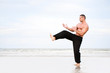 Man training karate at the beach