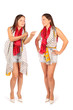 Two same women in studio on white background. First woman looks