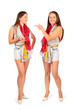 Two same women in studio on white background. First woman smiles