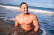 Young handsome muscular man at the sea
