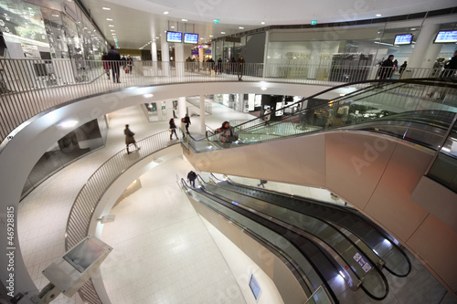 Photo: Escalator and people at three floors in shopping center Escalator and people at three floors in shopping center