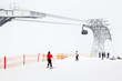 Big funicular in mountains. Skiers and snowboarders ride in Alps