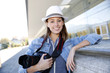 Photo: Smiling reporter standing outside with photo camera Smiling reporter standing outside with photo camera