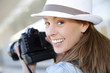 Photo: Smiling photographer with hat doing photo session Smiling photographer with hat doing photo session