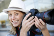 Beautiful woman photographer holding photo camera