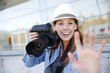 Photo: Cheerful photographer showing hand towards camera Cheerful photographer showing hand towards camera