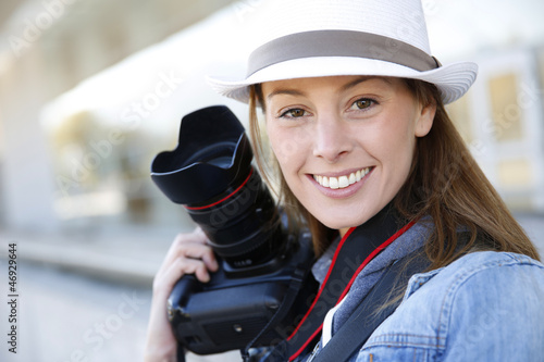 Photo: Beautiful woman photographer holding photo camera Beautiful woman photographer holding photo camera