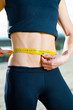 Woman measuring her waist
