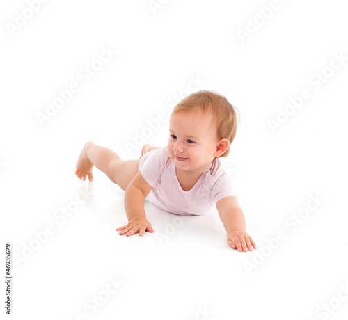 Photo: Impish little girl rolling on floor Impish little girl rolling on floor