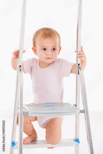 Photo: Beautiful baby girl climbing on ladder Beautiful baby girl climbing on ladder