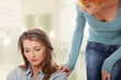 Troubled girl comforted by her friend