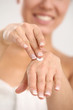 Close up of woman applying cream on her hand
