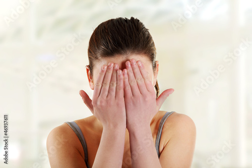 Photo: Teen woman covering her eyes Teen woman covering her eyes