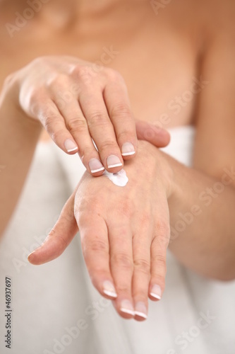 Photo: Close up of woman applying cream on her hand Close up of woman applying cream on her hand