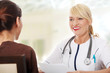 Mature female doctor talking with patient.