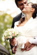 Beautiful bride and happy groom in autumn park