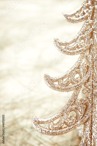 Photo: Golden Christmas tree close-up. Christmas concept. Golden Christmas tree close-up. Christmas concept.