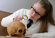 Woman examining a human skull