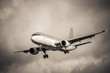sepia toned aircraft landing in turbulence