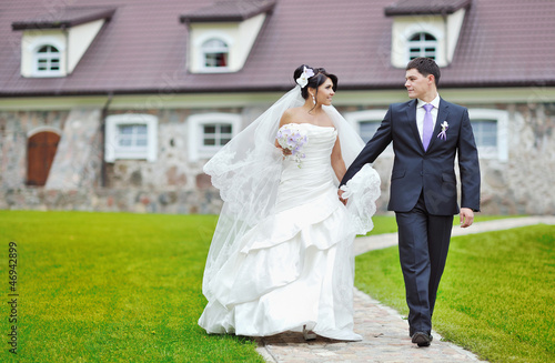 Photo: Bride and groom walking together Bride and groom walking together