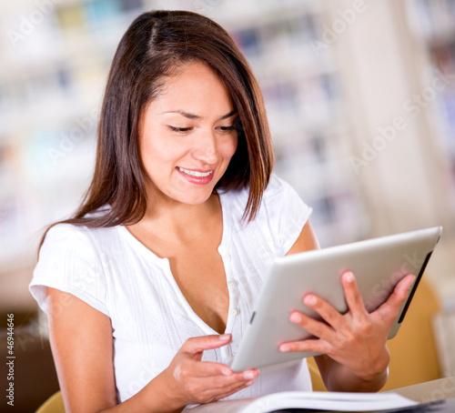 Photo: Woman reading on a tablet computer Woman reading on a tablet computer