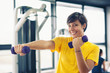 Photo: Young girl exercising with dumbbells in the gym. Young girl exercising with dumbbells in the gym.