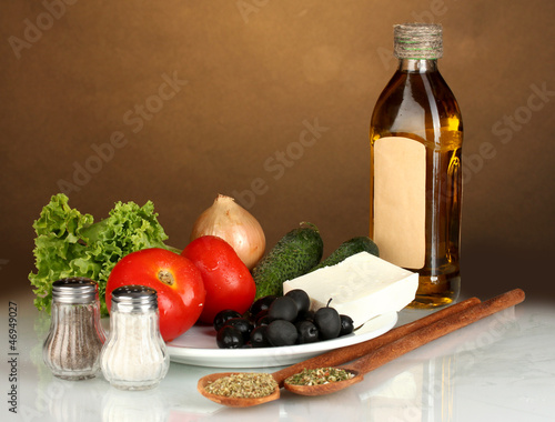 Photo: Ingredients for a Greek salad on brown background close-up Ingredients for a Greek salad on brown background close-up