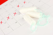 menstruation calendar with cotton tampons, close-up