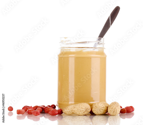 Photo: Delicious peanut butter in jar isolated on white Delicious peanut butter in jar isolated on white