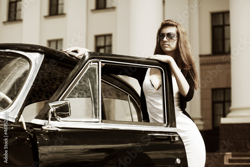 Photo: Young woman with retro car Young woman with retro car