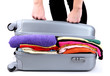 Girl tries to close the suitcase isolated on white