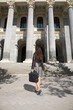 leather businesswoman in front of columns