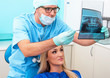 Dentist shows a patient x-ray