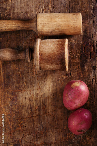 Photo: antique potato mashers on very old wooden table antique potato mashers on very old wooden table