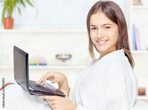 Photo: girl in bathrobe with computer girl in bathrobe with computer