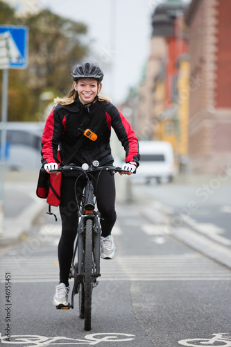 Photo: Female Cyclist With Courier Delivery Bag Female Cyclist With Courier Delivery Bag