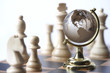 Chessboard with chess pieces and globe
