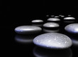 many pebbles in a row over black background
