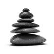 six pebbles stacked over white background with shadow