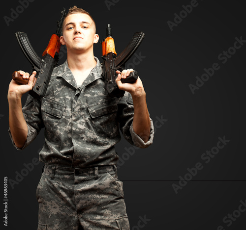 Photo: Portrait Of Soldier Holding Gun Portrait Of Soldier Holding Gun