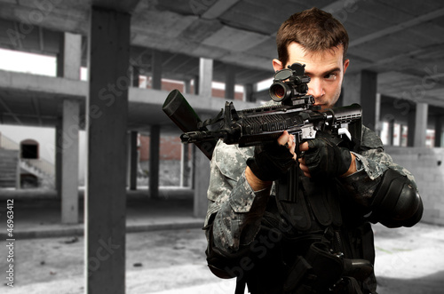 Photo: Portrait Of A Soldier Holding Gun Portrait Of A Soldier Holding Gun