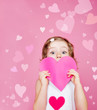Preschool girl holding paper heart