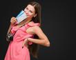 Young Woman Holding Boarding Pass And Camera