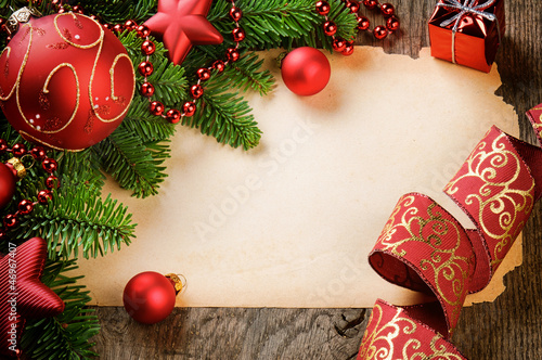 Photo: Frame with vintage paper and Christmas decorations Frame with vintage paper and Christmas decorations