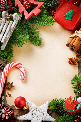 Photo: Frame with Christmas tree branches and vintage festive decoratio Frame with Christmas tree branches and vintage festive decoratio