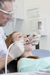 A male dentist treating a female patient