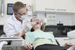 A male dentist treating a female patient