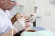 A male dentist treating a female patient.