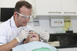 A male dentist working on a young boy patients teeth