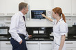A female dentist showing an x-ray to a male patient